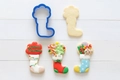 Blue plastic Christmas stocking cookie cutter with decorated gingerbread icing cookies - 7x4.5cm
