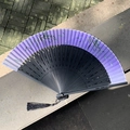 Traditional purple gradient folding fan with green bamboo leaf patterns and black tassel - Hollow Bamboo Node Purple Bamboo
