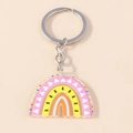 Rainbow acrylic keychain with pink and yellow tones featuring white triangle patterns - Triangle Print Rainbow