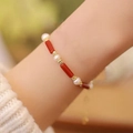 Elegant bracelet with red beads, white pearls, and gold spacers worn on wrist - Red Agate White Pearl Gold (MY37066)