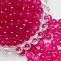 Macro detail of 8mm pink frosted glass beads with gold glitter for DIY jewelry making - Rose Red Brushed