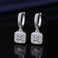 Square halo drop earrings with round center stone and silver finish on blue background - Square Bag One Carat Earrings Led-17