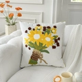 White square cushion cover with embroidered sunflower pattern on a plush sofa - Sunflowers in Bloom (With Core)