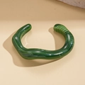 Close-up of wavy dark green acrylic open bangle with marble texture and polished finish - Dark Green