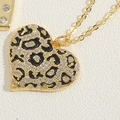Macro detail of heart pendant with leopard print enamel and sparkling pavé crystals - Leopard Enamel Heart (XL2690-5)