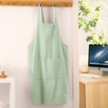 Light green cotton linen cross back apron with large front pocket hanging on hook - Mint Green