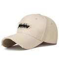 Creamy beige distressed cotton baseball cap with embroidered black patch and frayed edges - Light Beige