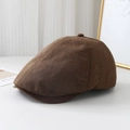 Detail view of deep brown fabric newsboy hat with a textured linen weave and top button - M (56-58cm) / Coffee