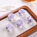 Detail of floral patterned resin hair claws in purple and white on a wooden tray - Clear Purple Cream White Heart