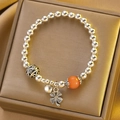 Silver beaded bracelet featuring a four-leaf clover charm and vibrant orange bead - Orange Cat Eye Clover Bracelet (X759)