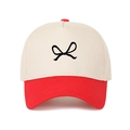 Close-up of a two-tone baseball cap with a black bow embroidery and contrasting red brim - Adjustable / Red