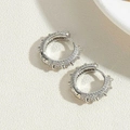 Close-up of silver hoop earrings featuring pavé cubic zirconia and small punk spike details - Rivet Punk Zircon Hoop / Silver