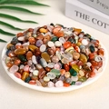 Mix of polished natural crystal stones in various colors displayed in a white plate - Colored Crystal (9-12mm) 100g