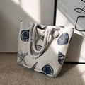 Detailed view of canvas tote bag with nautical starfish prints and thick rope handles - Ocean Shell