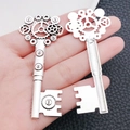 Macro detail of silver steampunk key pendant with mechanical gear design in palm - Gear Steampunk Key (8755)