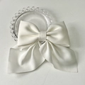 Elegant cream white satin bow hair clip with long ribbons on a glass tray decor - Pure White