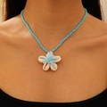 Bohemian blue beaded necklace featuring a white shell flower pendant on a model - White Flower (KX296)