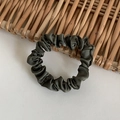 Dark green satin hair scrunchie with elegant pleats and glossy finish on wood background - Olive Green