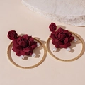 Detailed close-up of a deep red fabric rose earring with golden hoop and pearl accents - Silver Needle - Red Rose Drop Earrings / Wine Red Rose Circle