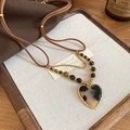 Macro view of heart pendant featuring tiger eye beads and tortoise texture on wood background - Heart Shape (Tiger Eye) / Coffee