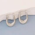 Detail of silver U-shaped hoop earrings with twisted texture and polished metal finish - Silver Style K7-74