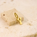 Minimalist golden letter Y pendant in stainless steel on a natural stone surface - Letter-Y / Gold