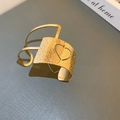 Detailed shot of gold drop-style cuff bracelet with hammered texture and heart cutout - Gold Heart Hollow Hammered Style (13#)