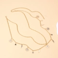Golden multi-layer body chain with sun moon and star charms on beige background - Small Star Moon / Gold