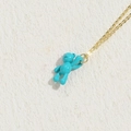 Vibrant blue bear pendant necklace with a delicate golden chain on a textured background - Small Bear / Blue