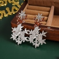 Macro detail of reindeer and snowflake earrings with brown enamel and clear rhinestones - #10 Silver Zirconia Christmas Reindeer
