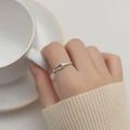 Minimalist silver titanium steel ring with geometric diamond accents on a female hand - US 5 / Silver