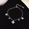 Detail of silver flower bracelet with pearls and sparkling zircons on black fabric - Silver
