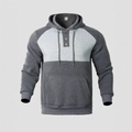 Detail of color-block hoodie featuring drawstring hood, half-button placket and front pocket - Marl Grey