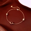 Détail du bracelet en or rose avec pierre oeil de tigre et boules serties de cristaux - Or rose