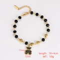 Detail shot of black beaded bracelet with golden bear charm and size measurements - Style 9 (Bear Charm)