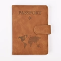 Detail of brown RFID passport holder featuring embossed world map and secure buckle - Camel