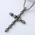 Macro detail of gothic skull cross pendant with oxidized silver finish on box chain - Skull Cross Style