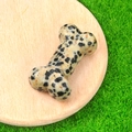 Dalmatian jasper bone-shaped crystal stone carving on a rustic wooden base - Dalmatian Jasper