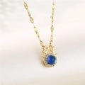 Golden reindeer necklace with blue zircon pendant and deer antler design on beige background - Gold Deer (Color Changing)