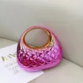 Detail view of pink metallic crossbody bag with diamond quilting and gold circular handle - Red Pink