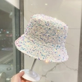 Iridescent white sequin bucket hat for women on display with a minimalist marble background - Sequined Bucket Hat - White