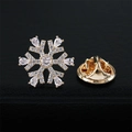 Snowflake brooch with sparkling crystals and gold plating on a black textured surface - Gold Snowflake (40206E)