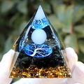 Resin pyramid with black gravel, golden foil, and blue tree of life held in hand - White Ball White Tree / Small