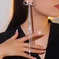 Elegant silver bow earrings with sparkling rhinestone tassels shown on a model - Silver Bow Long Fringe