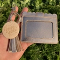 Detail view of pink gold card holder with tassel and engraved I love you wooden pendant - Champagne