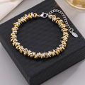 Two-tone twisted chain bracelet in gold and silver finish with lobster clasp and tag - Adjustable Size / Gold and Silver Two-tone