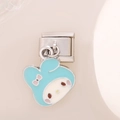 Detailed macro view of a My Melody enamel charm charm on a stainless steel bracelet module - 0199 - Blue Background With Pink Bow And Silver Trim