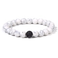 Detail of white turquoise marble beads with a single black lava rock bead on elastic cord - White Howlite (Elastic)