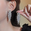 Luxurious silver tassel earrings with sparkling rhinestones and oval center stone detail - Silver Oval Main Stone Long Tassel Style (DTE1316466S)