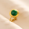 Macro shot of an open gold stainless steel ring with a round green malachite stone inlay - Gold-Green Stone